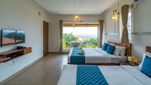 A hotel room with two beds, a TV, and a balcony with a view. - Ravishing Retreat  (Ramanagara)