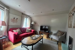 Relax in this inviting living room with a sofa, coffee table, and TV, perfect for unwinding.