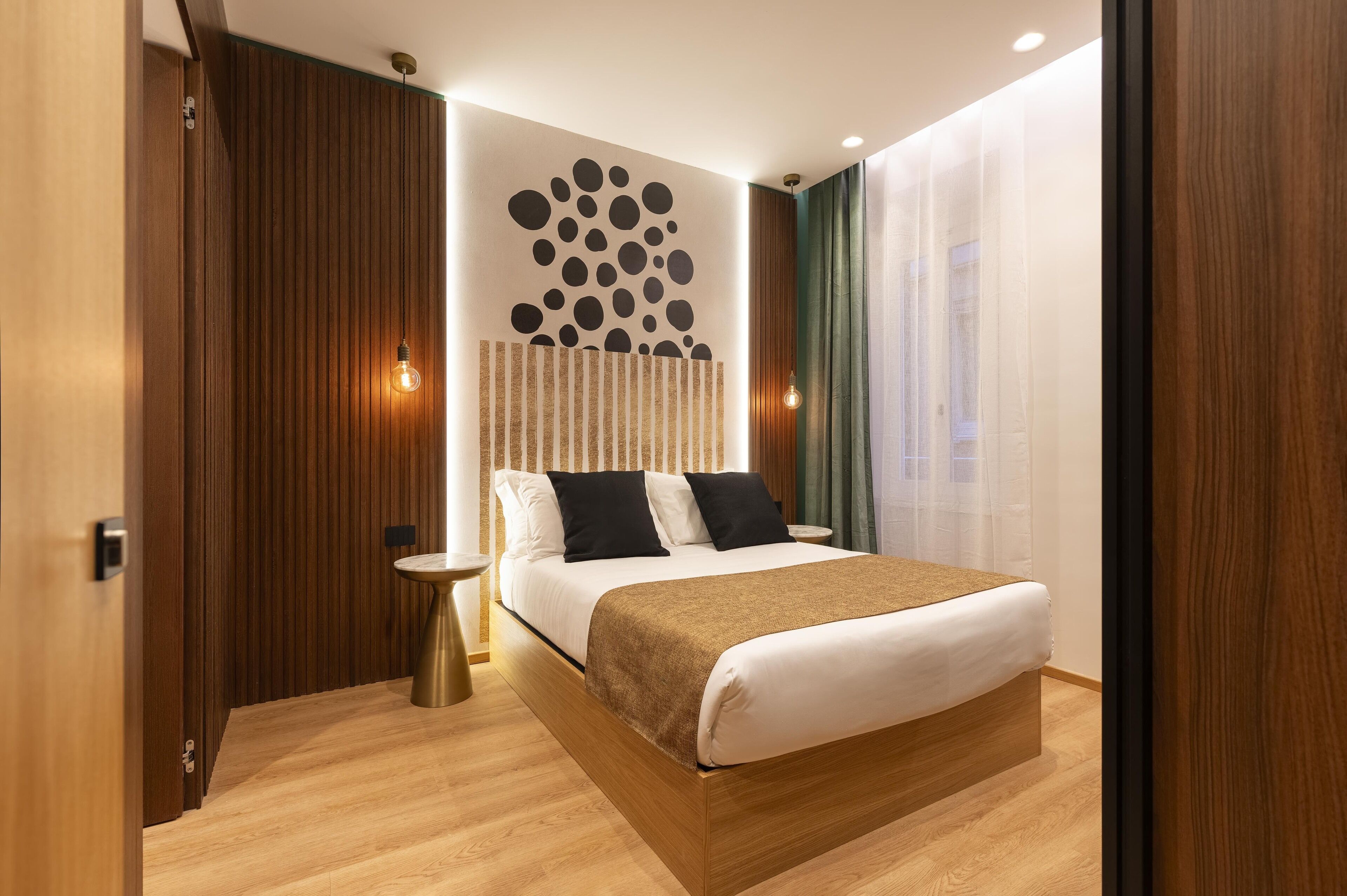 A modern bedroom with a wooden bed, a round wall decoration, and a small bedside table.