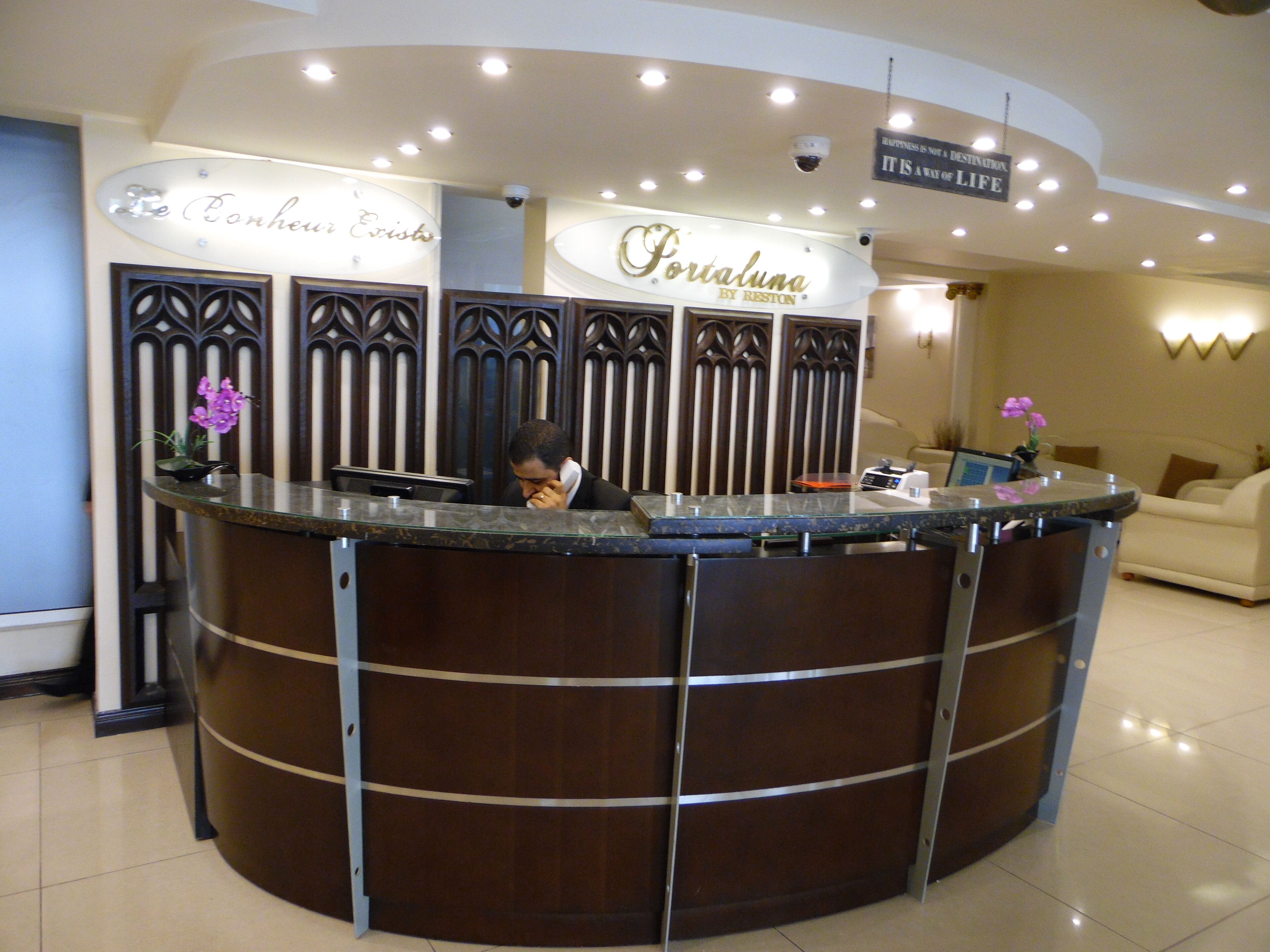 A reception desk with a sign that reads "Portalmana by Reston."