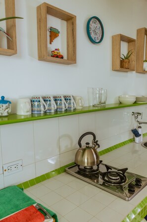Fridge, coffee/tea maker, cookware/dishes/utensils, dining tables