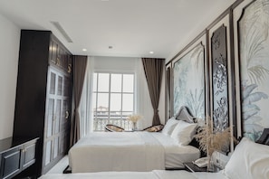 Family Triple Room | Minibar, in-room safe, desk, laptop workspace - Royal Hotel Phú Quốc (Phu Quoc)