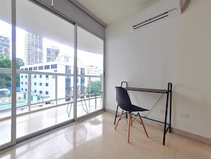 Enjoy a city view from the balcony, featuring a chair and table for a convenient space.