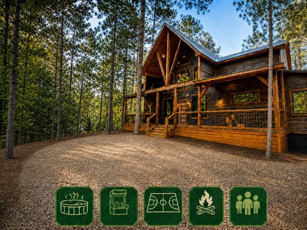 Une cabane en bois avec un porche, entourée d’arbres.