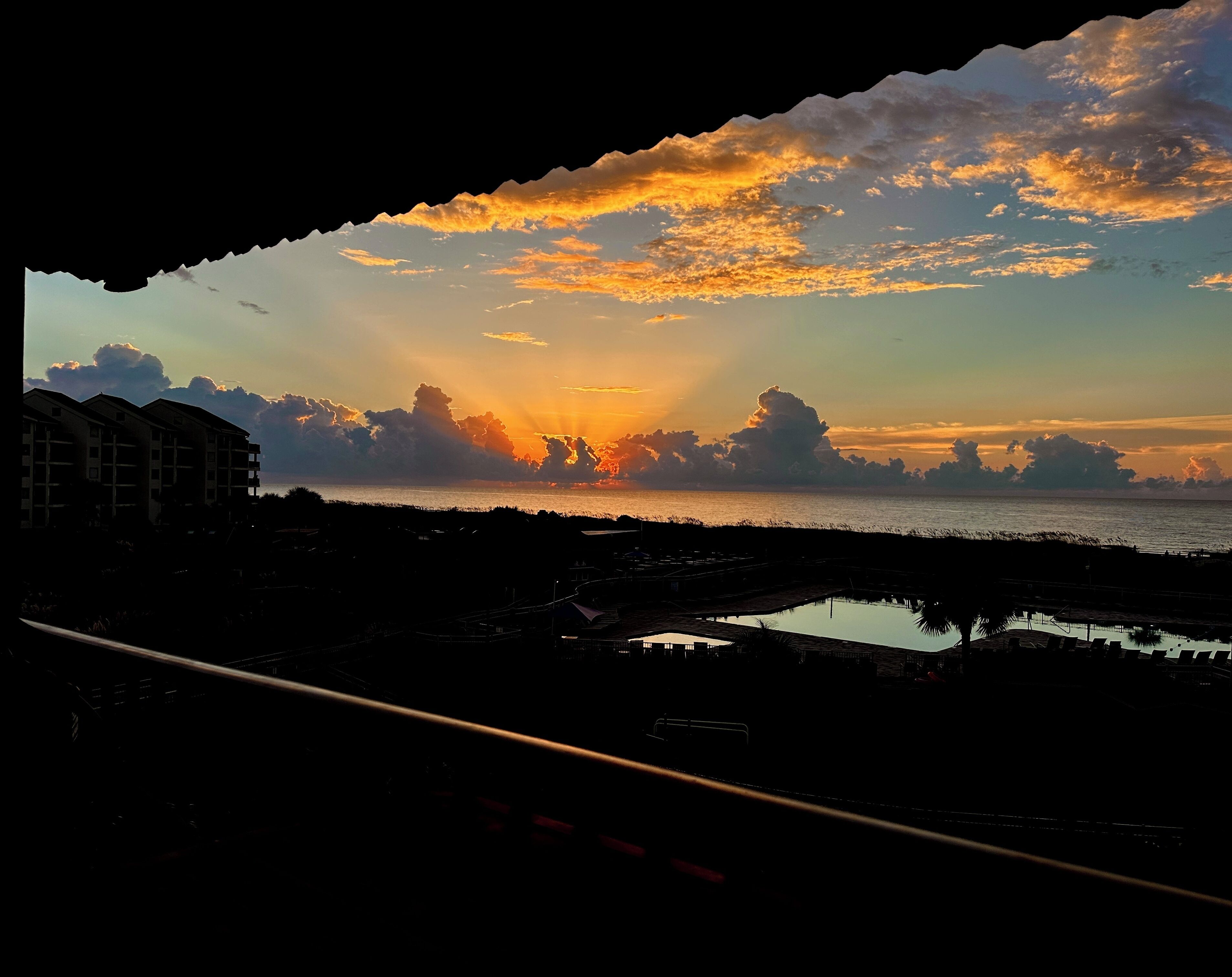 A coastal view with buildings and a body of water.