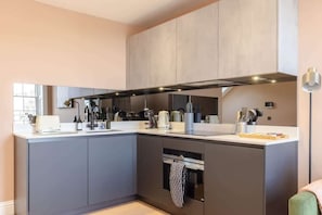 Enjoy cooking in this well-equipped kitchen with a central island, oven, and microwave.