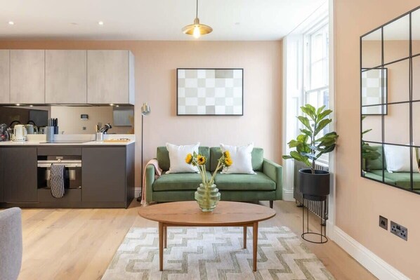 Relax in a spacious living area with a sofa, coffee table, and city view.