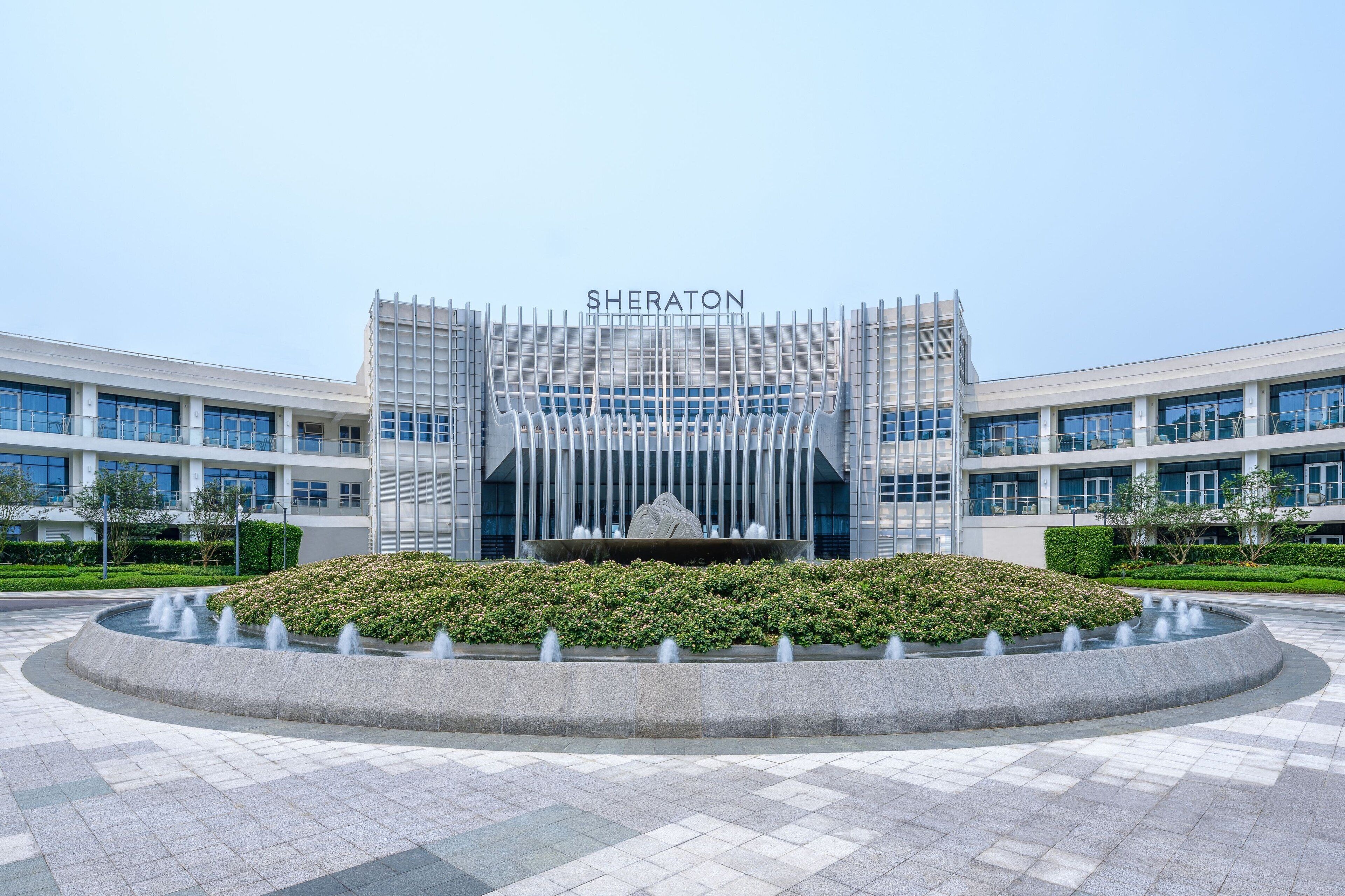 A modern building with the name 'SHERATON' prominently displayed.