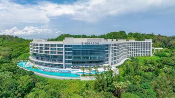 Surrounded by lush greenery, the hotel offers a serene environment.