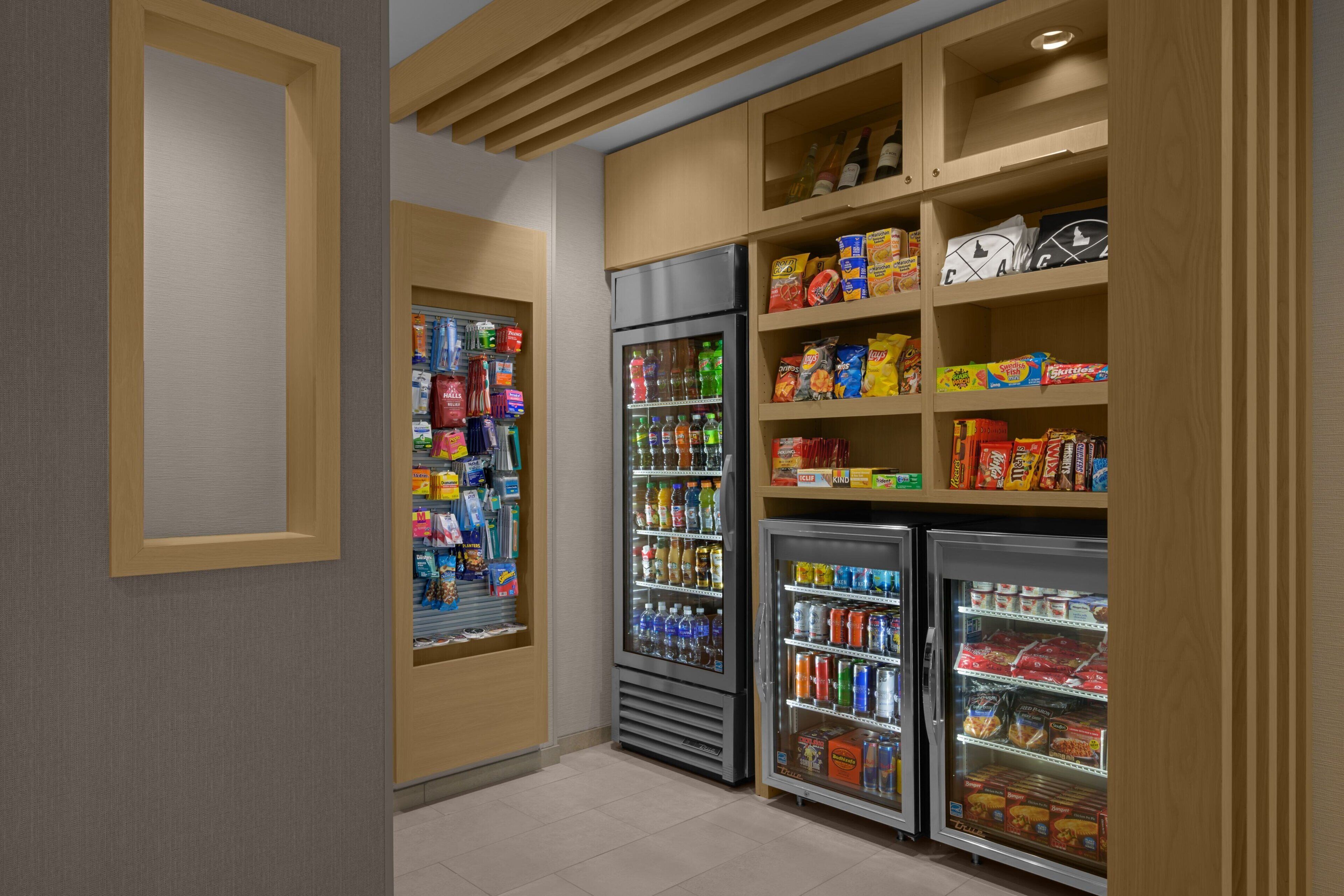 A self-service beverage station with refrigerated drink dispensers and snack shelves.