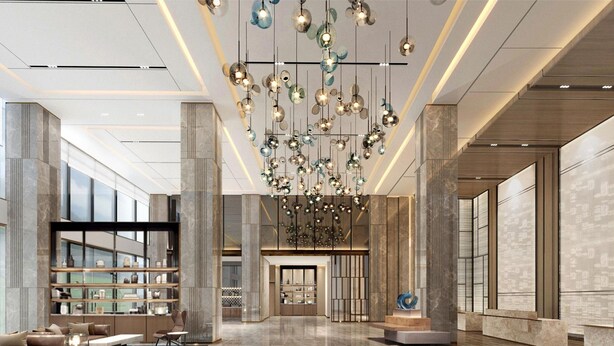 A spacious lobby with a modern chandelier, marble flooring, and a seating area with sofas and a coffee table. - Fairfield By Marriott Zibo (Zibo)