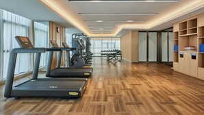 A modern gym with treadmills, weight machines, and a mirrored wall. - Fairfield By Marriott Zibo (Zibo)