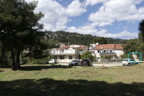 Houses on a hillside with red-tiled roofs and balconies.