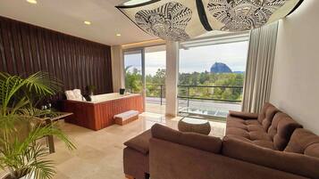Grand Suite with Jacuzzi | Living room | 50-inch LED TV with cable channels, TV, printers