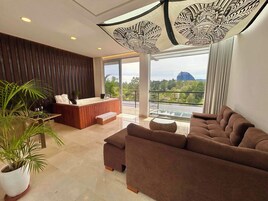 Grand Suite with Jacuzzi | Living room | 50-inch LED TV with cable channels, TV, printers