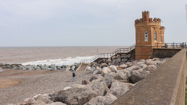A coastal tower with a staircase leading to a balcony overlooking the sea. - The Old Station House (Withernsea)
