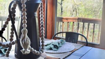 A table with a pitcher, a lamp, and placemats.