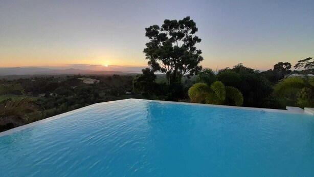 A swimming pool with a sunset view.
