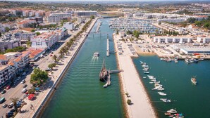 A coastal cityscape with a marina, buildings, and a road along the waterfront. - Stunning Modern Apartment [122] (Lagos)
