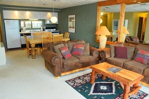 Cozy living space with a kitchenette, sofa, and dining area.