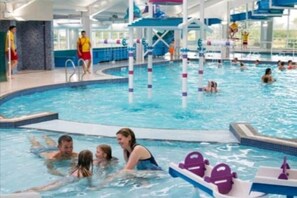 A swimming pool area with multiple lanes, a diving platform, and a water slide. - Seton Sands enjoy the beauty of your surroundings. (Pet friendly)  (Longniddry)