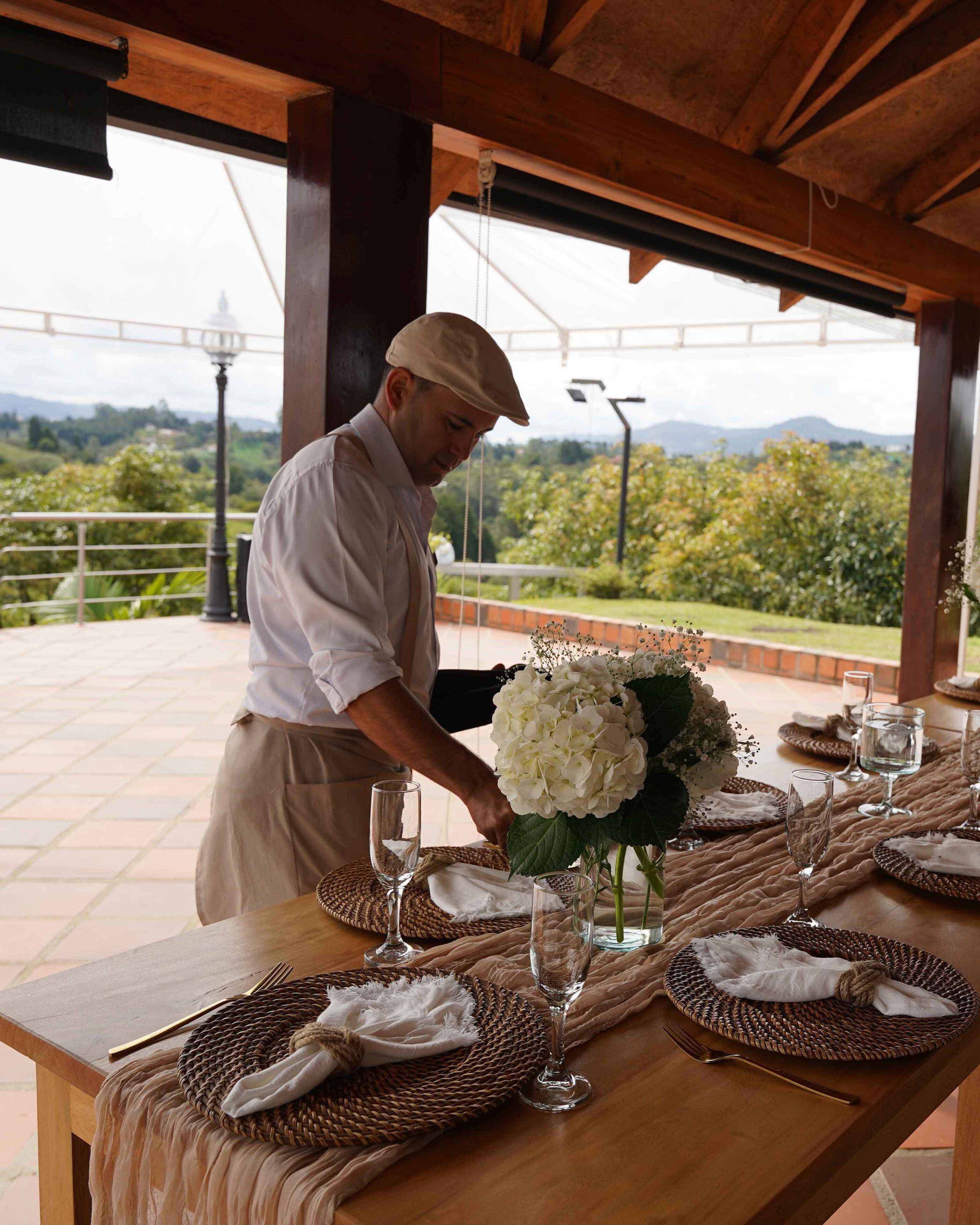 A table set for dining with a view of a mountainous landscape.