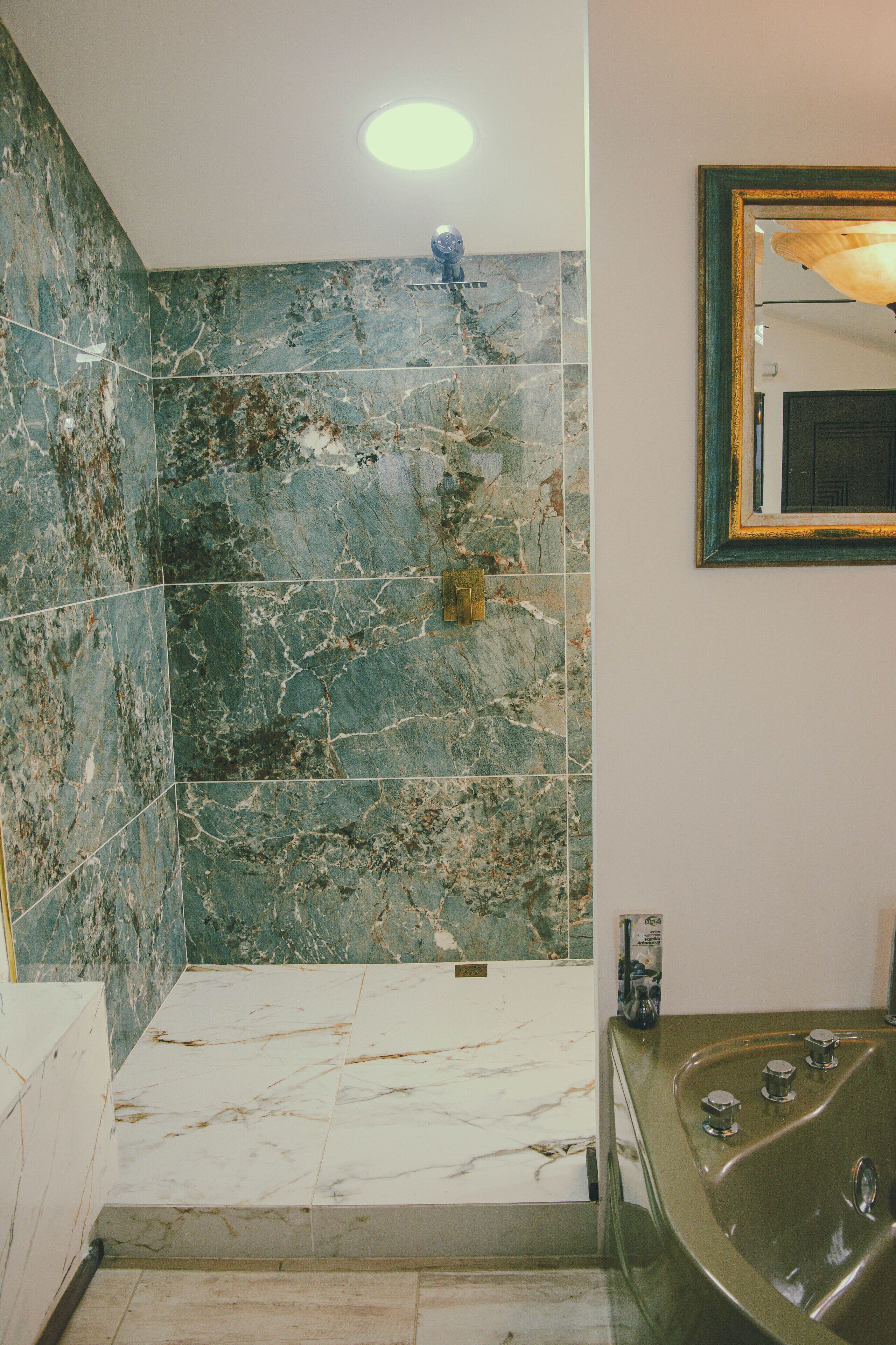 deluxe room | bathroom | shower, rainfall showerhead, free toiletries, hair dryer