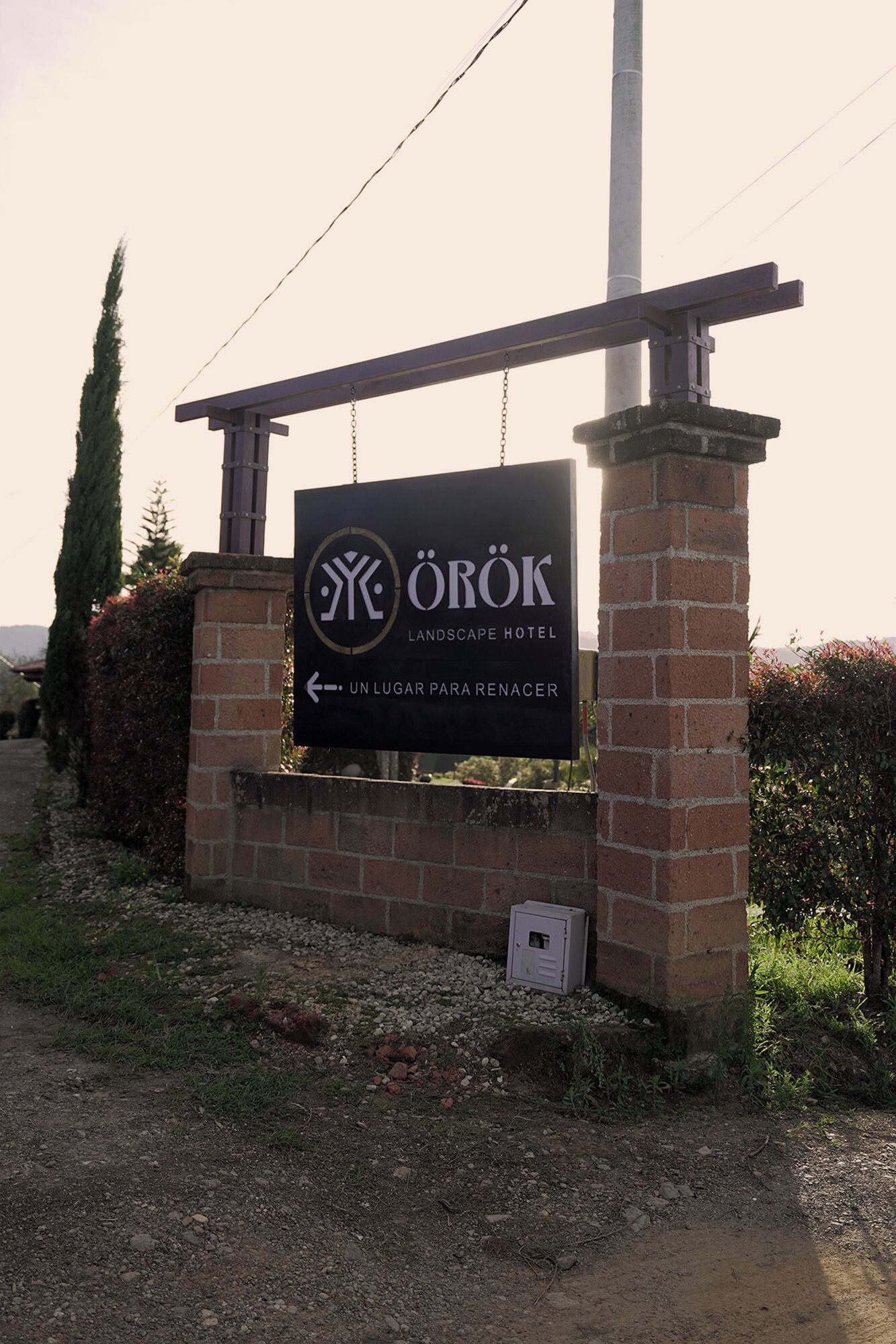 A sign for the Orok Landscape Hotel with a clear indication of the hotel's name and a directional arrow pointing to the location.