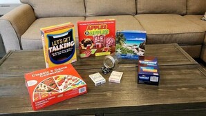 A coffee table with board games, a jar, and dice.
