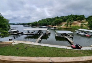 A lakeside dock area with multiple boat docks and a covered boat ramp.