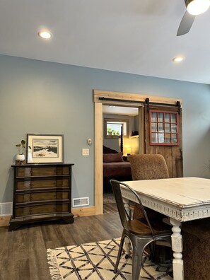 Enjoy meals in this dining area with a table for two and a comfortable chair.