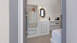 A modern bathroom with a walk-in shower, a vanity with a mirror, and a toilet. - Tatakis Design Hotel, Fira (Santorini)