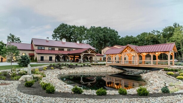A lodge with a large building and a covered deck area. - Tall Oaks Resort (Willoughby)