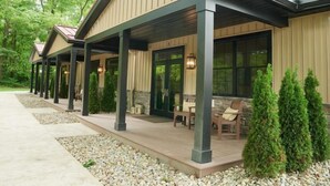 A covered outdoor patio area with seating and a stone pathway. - Tall Oaks Resort (Willoughby)
