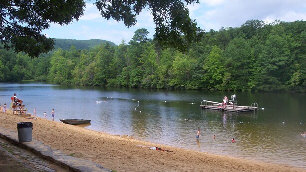A sandy beach with a dock and a boat.