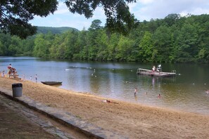 A sandy beach with a dock and a boat.