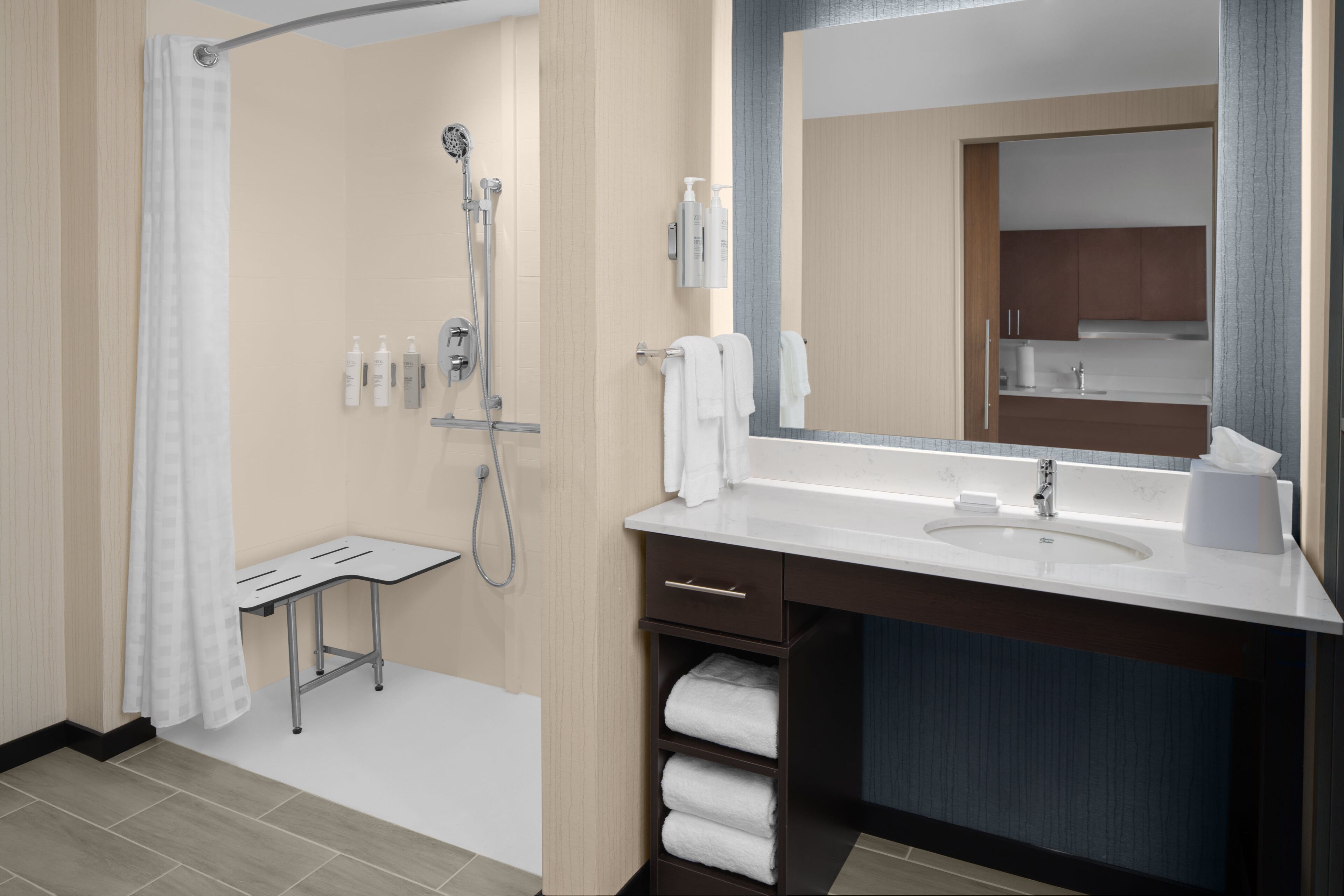 A modern bathroom with a shower, sink, and mirror.