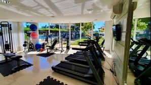 A gym with treadmills, exercise balls, and weight machines. - Beto Carrero, Vista Espetacular do Mar, Home Club (Penha)