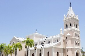 A church with a prominent bell tower and arched windows.
