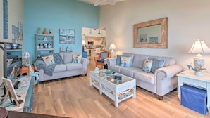 A living room with two sofas, a coffee table, and a dining area in the background. - Topsail Beach Oceanfront Oasis w/ Stunning Views! (Sneads Ferry)