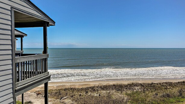 A beachfront property with a wooden deck overlooking the ocean. - Topsail Beach Oceanfront Oasis w/ Stunning Views! (Sneads Ferry)