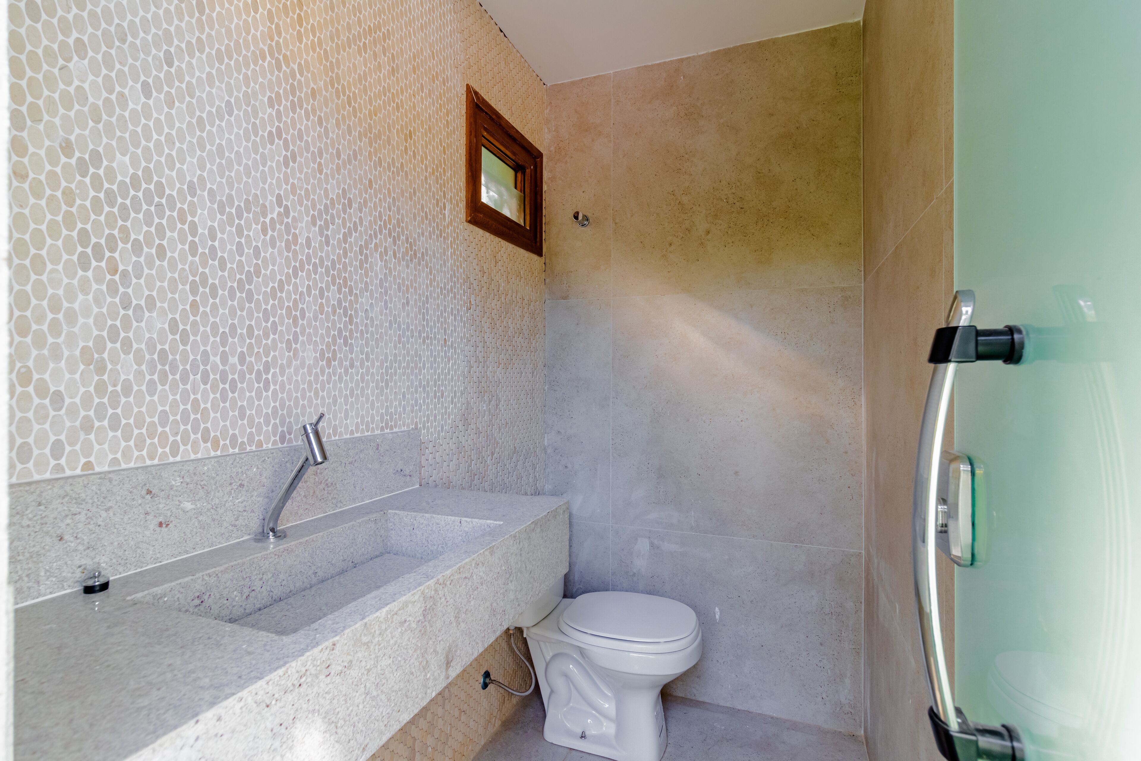 A bathroom with a sink, toilet, and shower area.