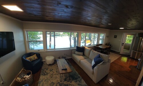 Enjoy Lake life in this renovated Camp, 50 ft from water. Private dock, beach.