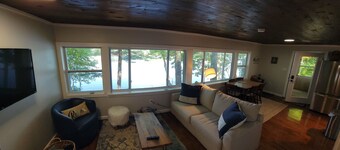 Enjoy Lake life in this renovated Camp, 50 ft from water. Private dock, beach.