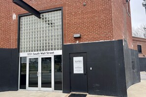 A building with a large glass entrance and a sign indicating '1051 South Wall Street'.