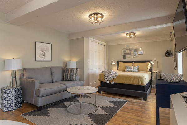 Suite featuring a queen size bed and cozy sofa