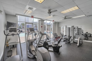 A gym with treadmills, elliptical machines, and weight equipment.