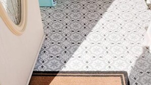 A welcome mat with the word "WELCOME" at the entrance of a building.