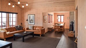 A cozy wooden interior with a sofa, coffee table, and dining area. - Stunning home in Gol with sauna (Gol)