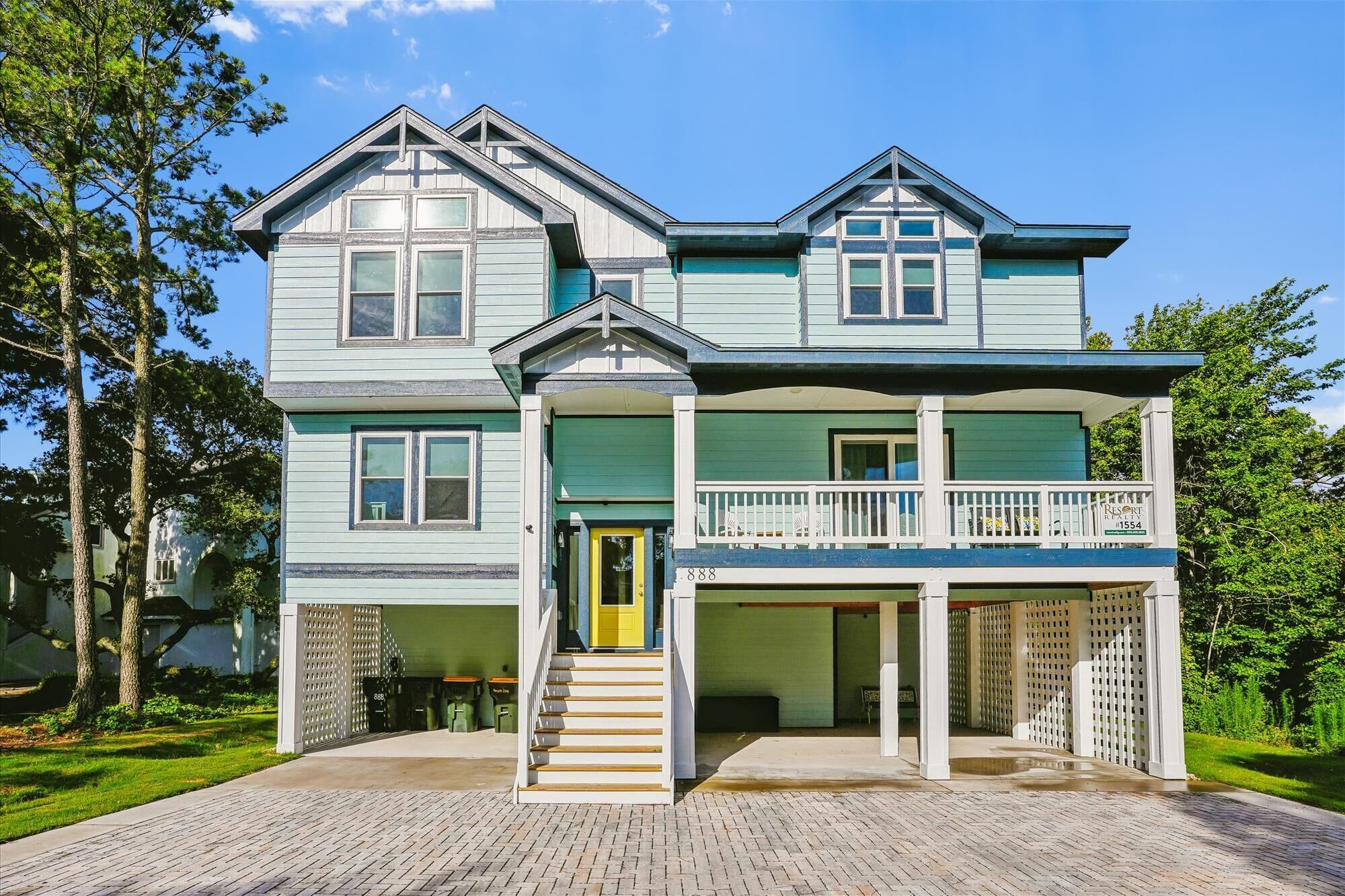 A two-story house with a front porch, a covered entryway, and a balcony.
